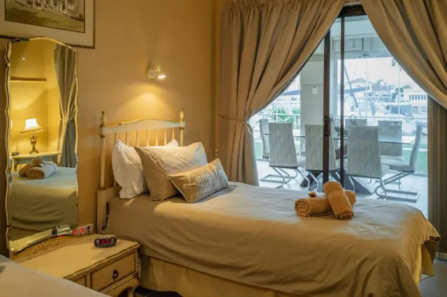 Bedroom with sliding doors opening onto the patio and marina