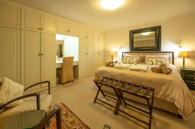 King suite with built-in cupboards and a dressing table