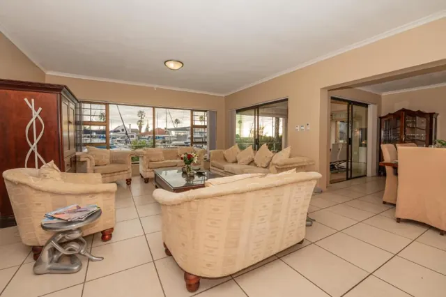 Open-plan living room with marina views and a dining area beyond