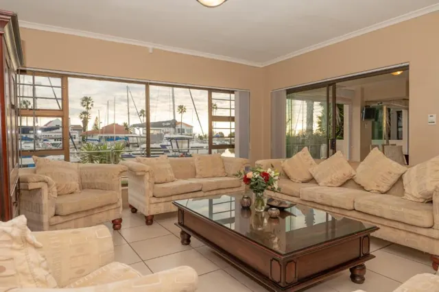Lounge with deep sofas and windows looking straight onto the marina