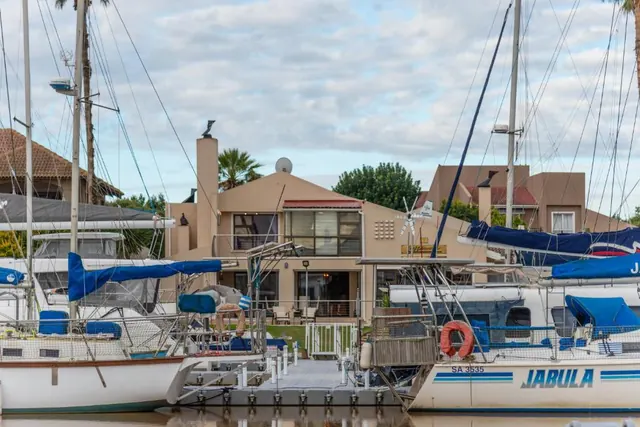 The Waterfront Guest House seen across the marina between moored yachts