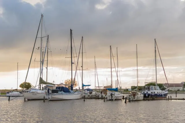 Yachts moored in Port Owen Marina under an evening sky